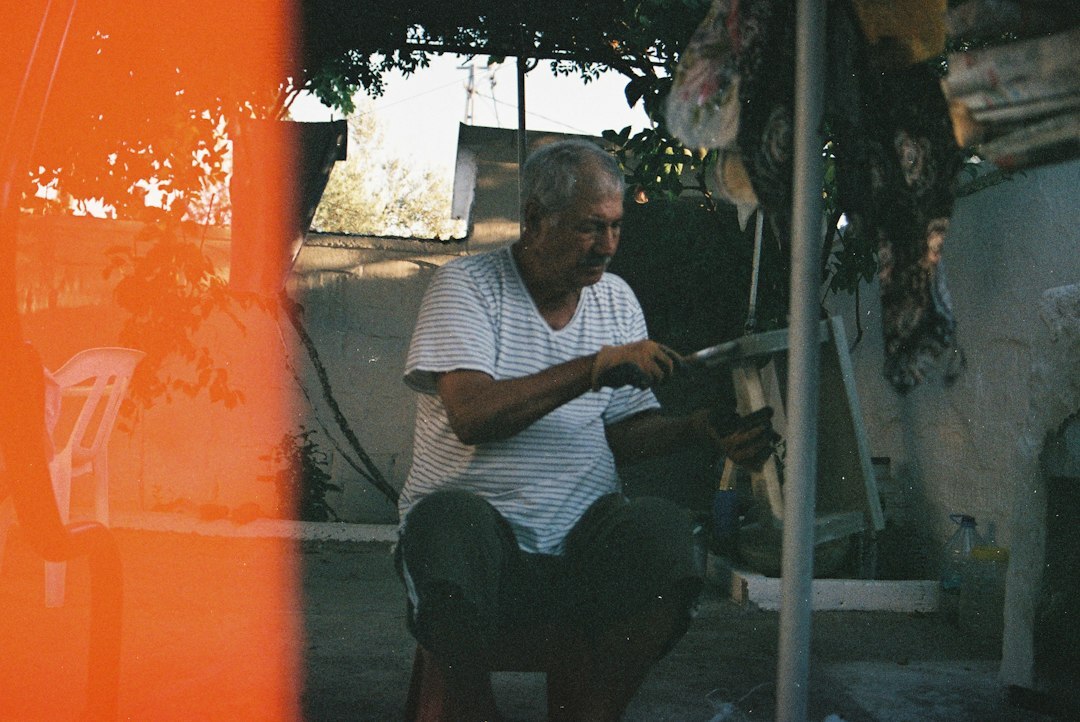 elderly man fixing chair
